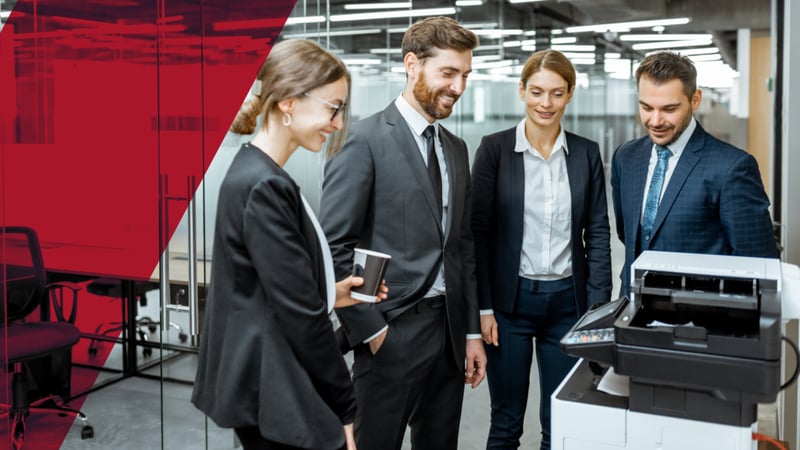 workers standing at the office printer